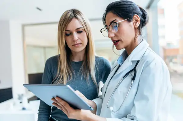 Doctor explaining results on a tablet to patient
